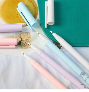 Close-up of pastel macaron-colored gel pens with fine tips on a creative desktop setup