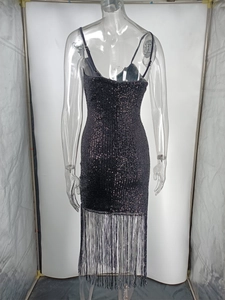 Detail of black sequined dress back view featuring elegant long fringe tassels