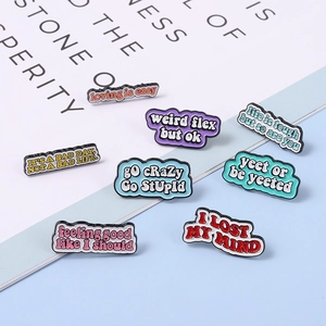 Detailed view of colorful enamel letter pins with motivational English phrases on background
