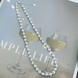 Minimalist S925 sterling silver beaded necklace with heart pendant in a simple life scene