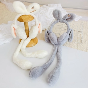 Detail of plush rabbit earmuffs with soft faux fur texture and Love embroidery