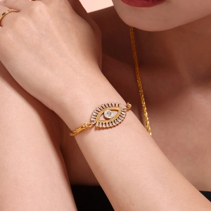 Elegant gold Evil Eye bracelet with pavé cubic zirconia worn on a woman's wrist
