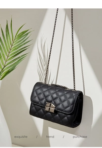 Exquisite black quilted crossbody bag featuring a classic metal lock and chain strap detail