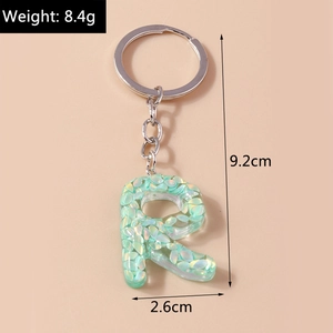 Letter R keychain with green shell resin detail showing 9.2cm length and 8.4g weight
