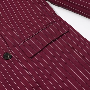 Close-up of burgundy striped blazer showing pocket flap and tortoiseshell button detail