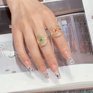 Detail of retro adjustable rings with real dried flower specimens and lucky four-leaf clover