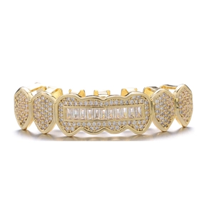 Macro shot of gold hip hop grillz with rectangular crystals and pavé diamonds