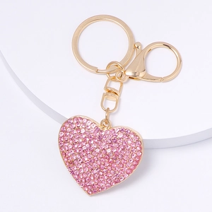 Sparkling pink rhinestone heart keychain with gold alloy lobster clasp on white background