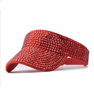 Close-up of sparkling red rhinestones on the surface of an adjustable sun visor cap