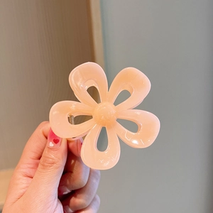 Close-up of peach jelly camellia hair claw clip with transparent acrylic petals