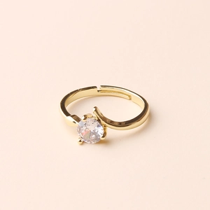 Detailed macro view of gold adjustable ring featuring a round sparkling gemstone inlay