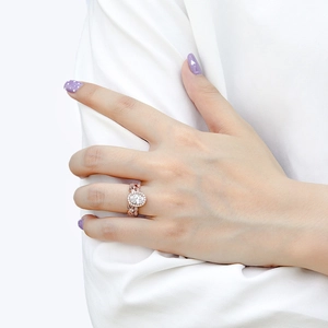 Detailed macro view of an oval zircon ring in rose gold with vintage floral engraving