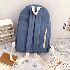 Rear view of blue backpack featuring wide shoulder straps and a vertical anti-theft zipper pocket