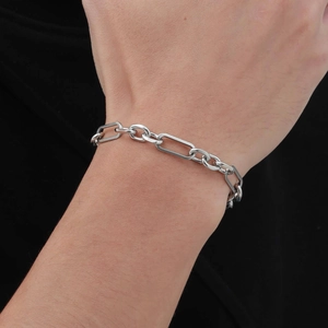 Close-up of polished silver stainless steel chain bracelet on male model wrist
