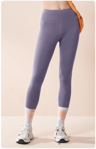 Detail of high-waist light purple yoga leggings showing seamless elastic fabric texture