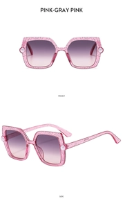 Detail of pink glitter kids sunglasses with gradient lenses and pearl accents on the frame