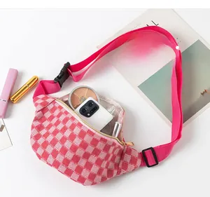 Detailed interior of pink checkered waist bag showing capacity for phone and cosmetics
