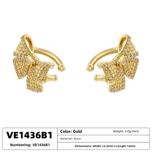 Macro shot of gold-plated brass bow ear cuffs with dimensions 13.5mm by 14mm