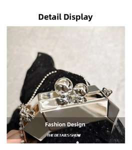 Detail view of silver mirror acrylic clutch featuring dual sphere clasp and bead chain