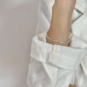 Minimalist S925 sterling silver cross chain bracelet worn with a white linen shirt