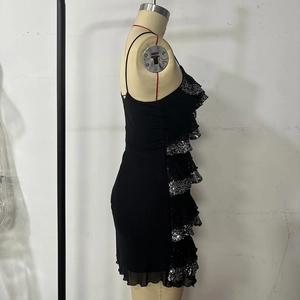 Detail of black party dress featuring layered silver sequins and ruffled chiffon hemline