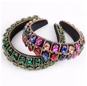 Detail of baroque headbands with emerald and multicolor crystals on thick velvet sponge