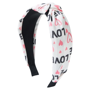 White knotted headband with pink hearts and LOVE lettering for Valentine decoration