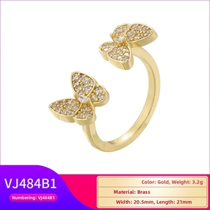 Detail view of gold-plated brass double butterfly ring with micro-set cubic zirconia