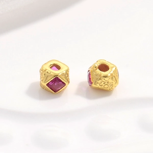 Macro shot of S925 sterling silver beads with gold plating and pink square gemstones