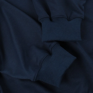 Detailed view of the navy blue sweatshirt ribbed cuff and premium knit fabric texture