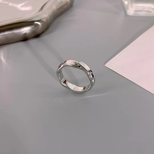 Detailed view of silver Mobius ring featuring a minimalist twisted wave design in steel