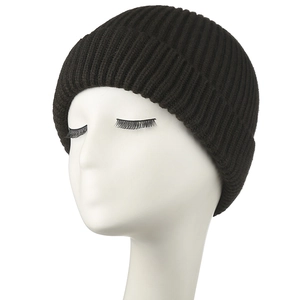 Close-up of black ribbed knit beanie showing thick texture and elastic vertical weave