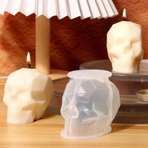 Detailed view of geometric skull candle with its translucent silicone mold in a soft setting