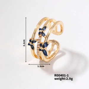 Detailed view of golden triple-layered butterfly ring with blue marquise gemstones and zircon