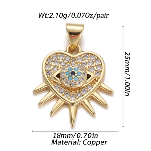 Detail of gold heart charm with cubic zirconia evil eye showing size specifications