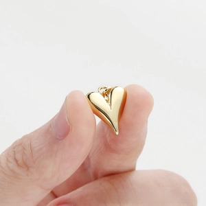 Detailed view of polished heart pendant in 18K gold plating for DIY jewelry making