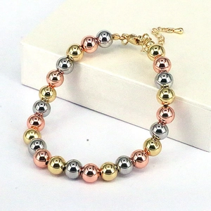 Three-tone polished metal bead bracelet set with lobster clasp in gold and rose gold finish