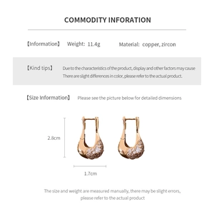Detailed view of U-shaped zircon earrings in rose gold copper with 11.4g weight specifications
