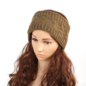 Detail of tan cable knit headband on mannequin showing thick winter warm texture