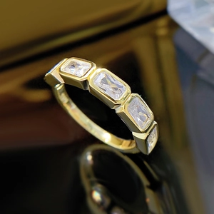 Gold-plated rectangular zircon row ring with five sparkling clear stones in a gold setting