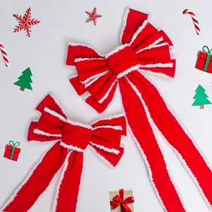 Detail of red velvet Christmas bows with white faux fur edges in two different sizes