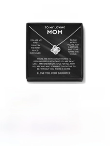 Detail of clover love knot pendant in premium jewelry gift box with mother's day card