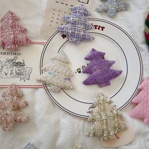 Detailed view of tweed Christmas tree ornaments in assorted colors with gold thread detail