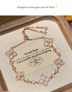 Detailed view of rose gold flower bracelet with pink shell inlays and pavé zircon stones