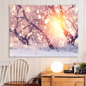 Detail of snowy forest wall tapestry with warm light bokeh in a cozy room setting