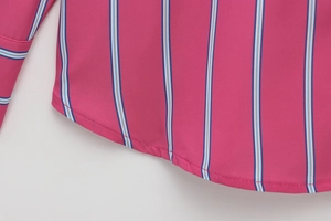 Detail of curved hem and fine stitching on a pink and blue striped fabric shirt