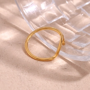 Macro shot of 18K gold plated minimalist ring featuring a creative irregular wave design