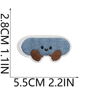 Detail showing cartoon embroidered patch with size measurements of 5.5cm by 2.8cm