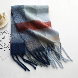 Detail of thick rainbow plaid scarf with long tassels and soft brushed texture
