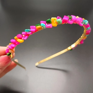 Detailed close-up of handmade gold wire crown headband with colorful crystal stones